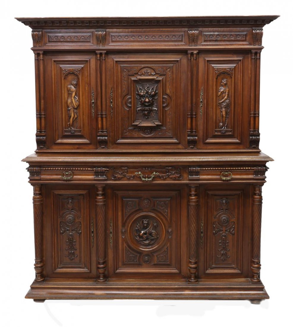 FRENCH RENAISSANCE REVIVAL HEAVILY CARVD SIDEBOARD: French Renaissance Revival heavily carved sideboard, 20th c., the corniced top over dentil trim and rosette frieze, above three paneled doors, a Green Man mask flanked by classical figures, opening to