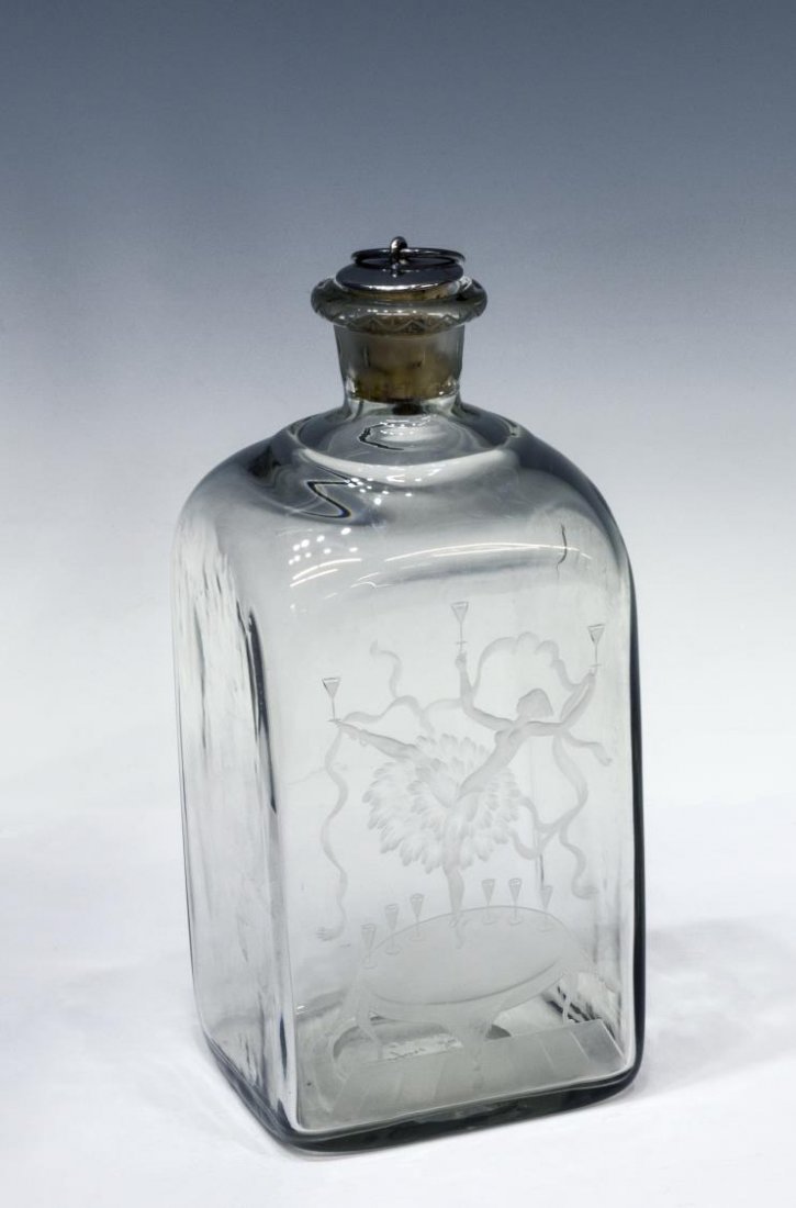 SIMON GATE ORREFORS ENGRAVED GLASS DECANTER BOTTLE: Orrefors engraved colorless glass bottle / decanter, design by Simon Gate (Swedish, 1883-1985), showing a wild beauty, balancing drinks upon her hands and toes, stands perched upon a table top, in her