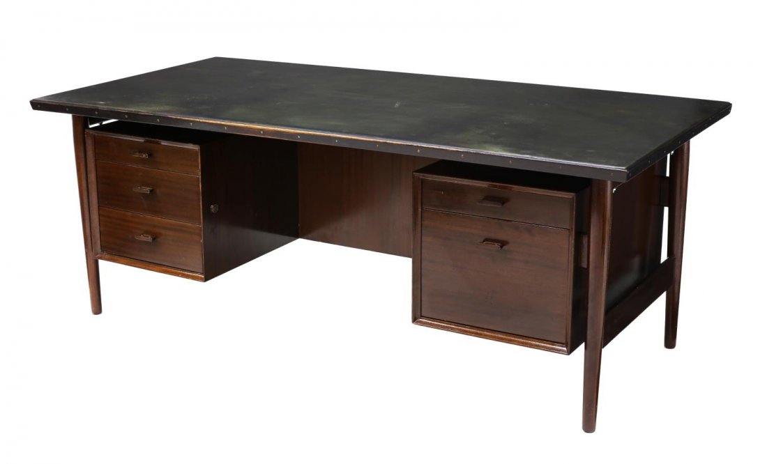 DANISH LEATHER TOP EXECUTIVE DESK BY ARNE VODDER: Danish mid-century modern leather top executive desk, design by Arne Vodder (Finnish 1926-2009), the black leather wrapped surface above five drawers, rising on tapered cylindrical legs, some scratchi