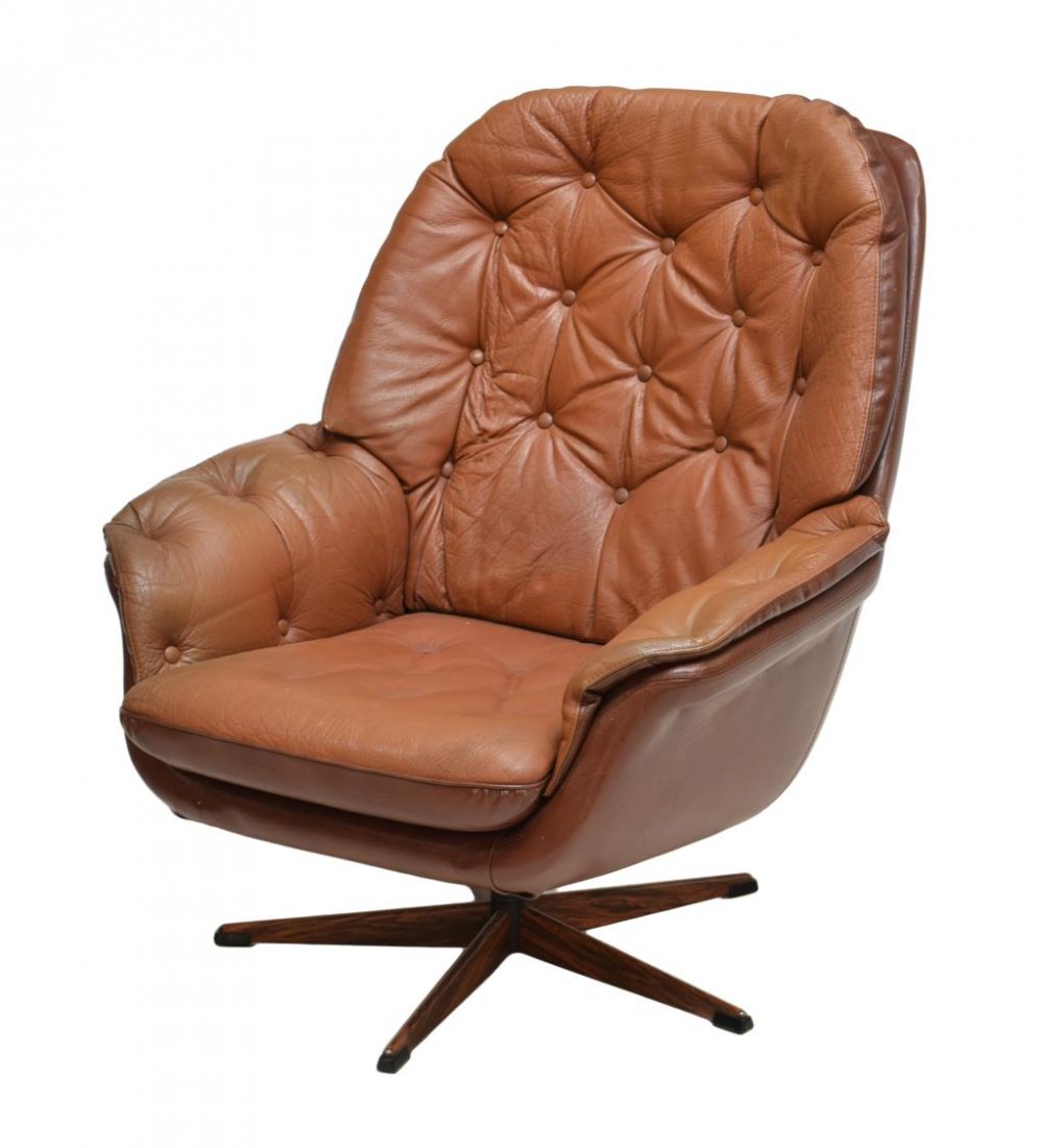 DANISH MID-CENTURY MODERN FAUX LEATHER ARMCHAIR: Danish mid-century modern brown faux leather armchair, 1960s, having a tufted backrest and arms over the removable cushion, rising on swivel five-legged base, 35"h, 32"w, 24"d Start Price: $80.00