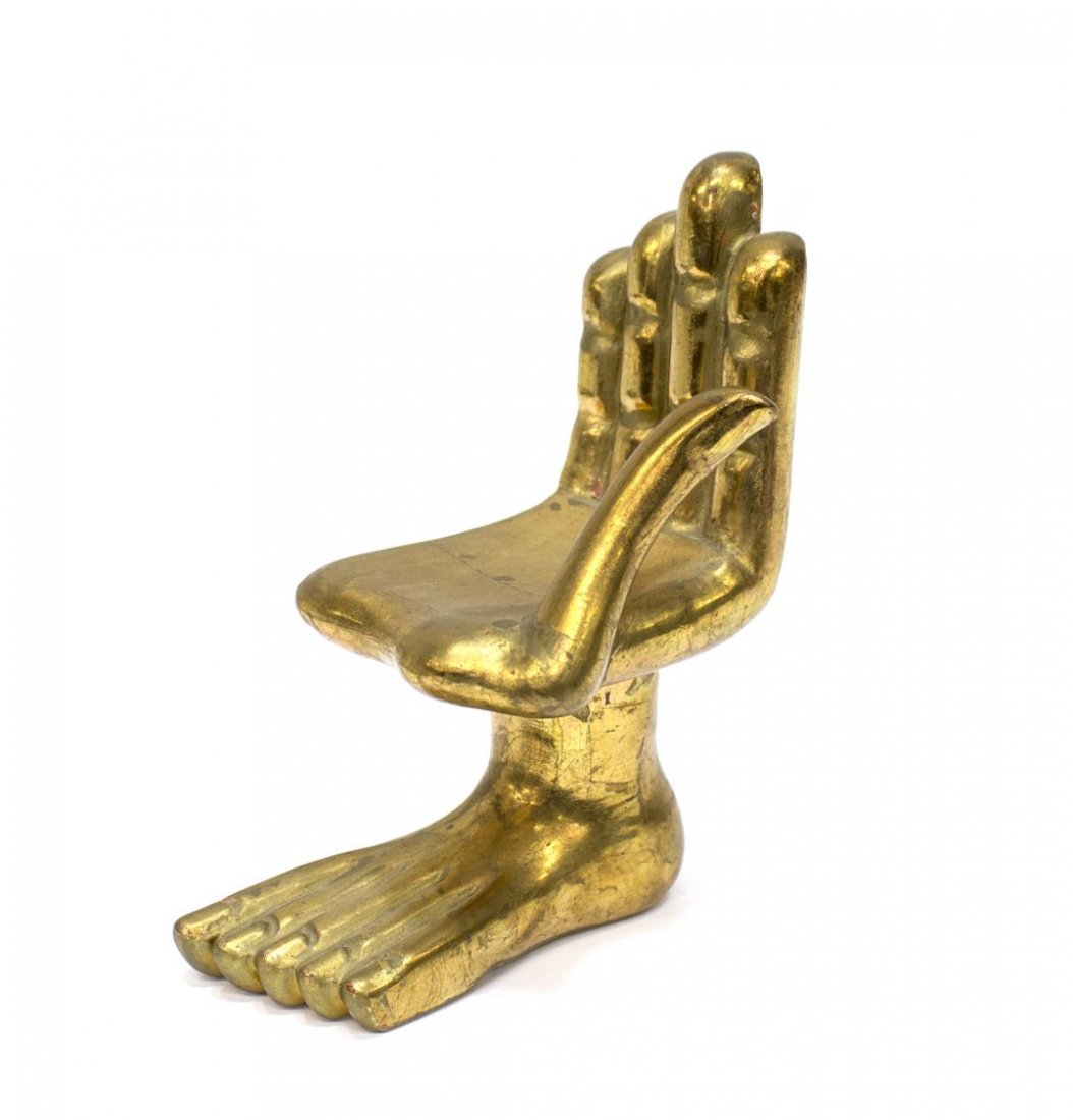 PEDRO FRIEDEBERG BRIGHTLY GILDED HAND FOOT CHAIR: Pedro Friedeberg (Mexican / American, b. 1936) carved wood sculpture, Gilded Hand and Foot, a miniature chair, some craquelure and loss to finish, signed underfoot, 6"h, 3"w, 4.25"d, .25lb *Provenance