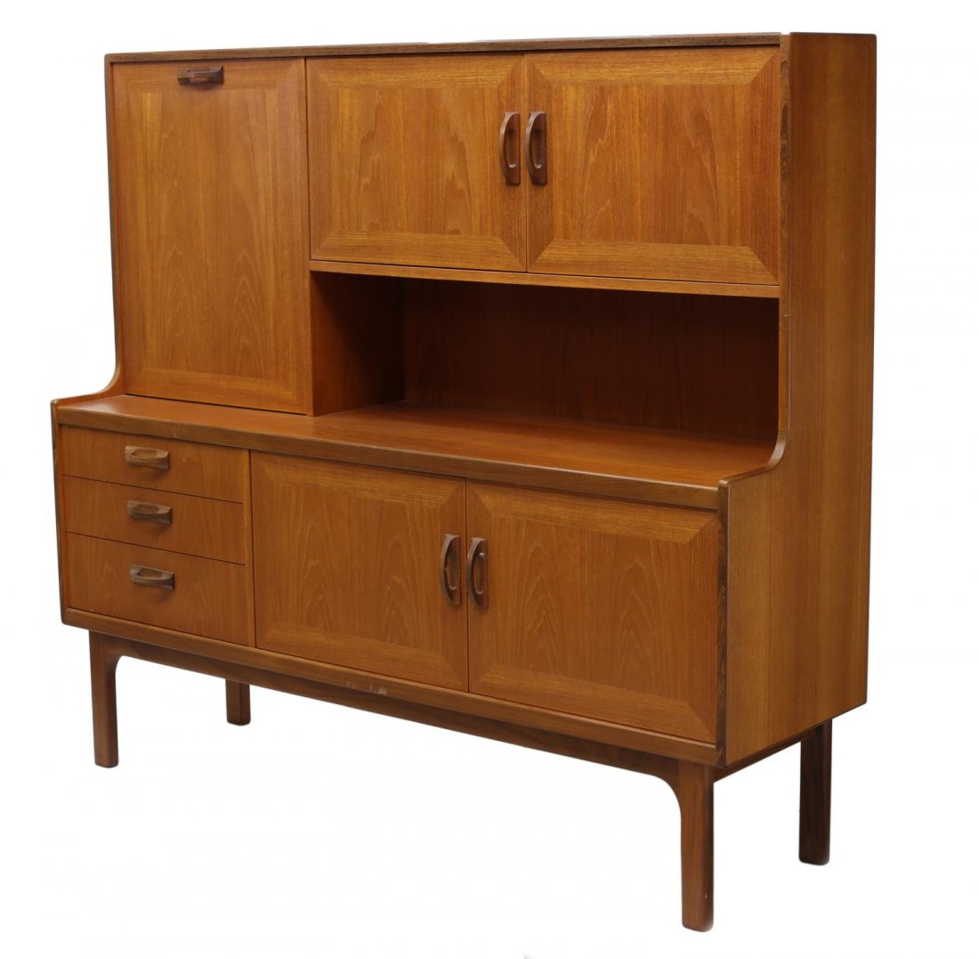 DANISH MID-CENTURY MODERN TEAKWOOD SIDEBOARD: Danish mid-century modern teakwood sideboard, 1960's, the upper part with two doors, a drop front for writing, three lower drawers and two doors, all rising on squared supports, 57.25"h, 63"w, 19"d St