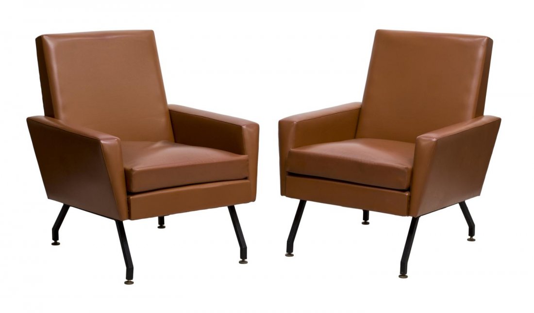 (2) ITALIAN MID-CENTURY MODERN LOUNGE CHAIRS: (pair) Italian mid-century modern design faux leather arm chairs, c. 1960's, each having slightly reclined back and loose cushion, over black steel legs, flattened gilt disc feet, approx 33"h, 26.5"w,