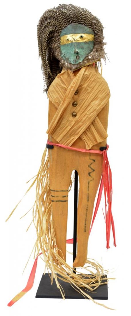 JIM COTTER MIXED MEDIA SCULPTURE, SPIRIT CHASER: Jim Cotter (American, 20th c.) mixed media sculpture, Spirit Chaser, the standing carved wood figure with corn husk wrap, pheasant feather and raffia headdress, verde metal mask with gilded band, moun
