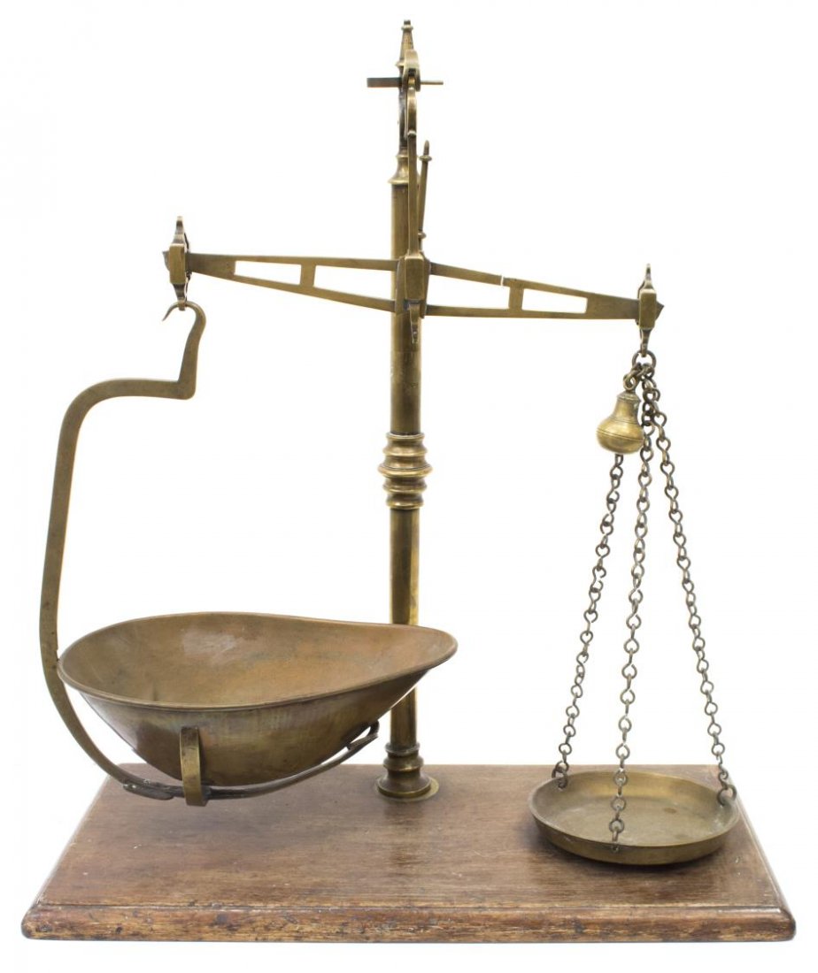 ENGLISH VICTORIAN SET OF BRASS SCALES, C. 1890: English Victorian set of brass scales, McLean & Co, Newcastle, England, having a central column with a scrolling arm, issuing balancing arm above chains holding trays, rising on wooden plinth, 23"h, 2