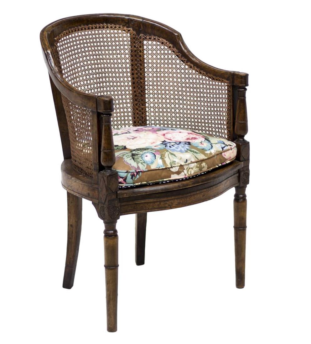FRENCH LOUIS XVI STYLE CARVED WALNUT FAUTEUIL: French Louis XVI style carved walnut caned fauteuil, 19th c., the curved tri-part back and armrests terminating in carved rosette handholds over turned supports, rising on tapered legs, accompanied by