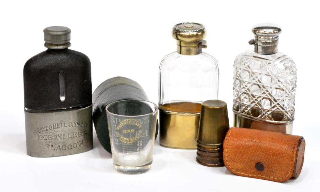 (5) TRAVELING DRINKWARE, STERLING FLASKS, GLASSES: (lot of 5) Travelling drinkware related items, comprising: (1) sterling and cut glass flask, W & G Neal, London c. 1890; hallmarked at neck and base; (1) gold washed sterling and glass flask, London h
