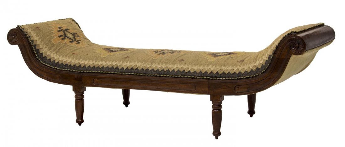CARVED MAHOGANY SOUTHWESTERN UPHOLSTERED DAYBED: Carved mahogany curved daybed, late 19th c., having a Native American or Mexican woven wool textile upholstery, over scrolling sides centered with rosettes, rising on turned legs, 26"h, 84"w, 27.25"d 
