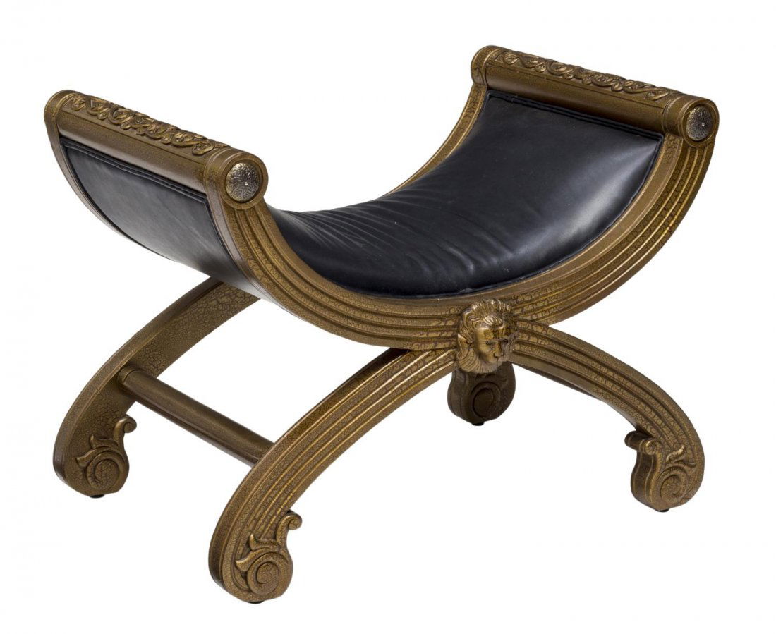 HENREDON LEATHER & CARVED WOODEN CURULE STOOL: Carved wooden curule stool, by Henredon, having foliate carved armrests over the black leather curved cushion seat, grooved frame accented by lion mask, rising on scrolling feet with joined support, 2