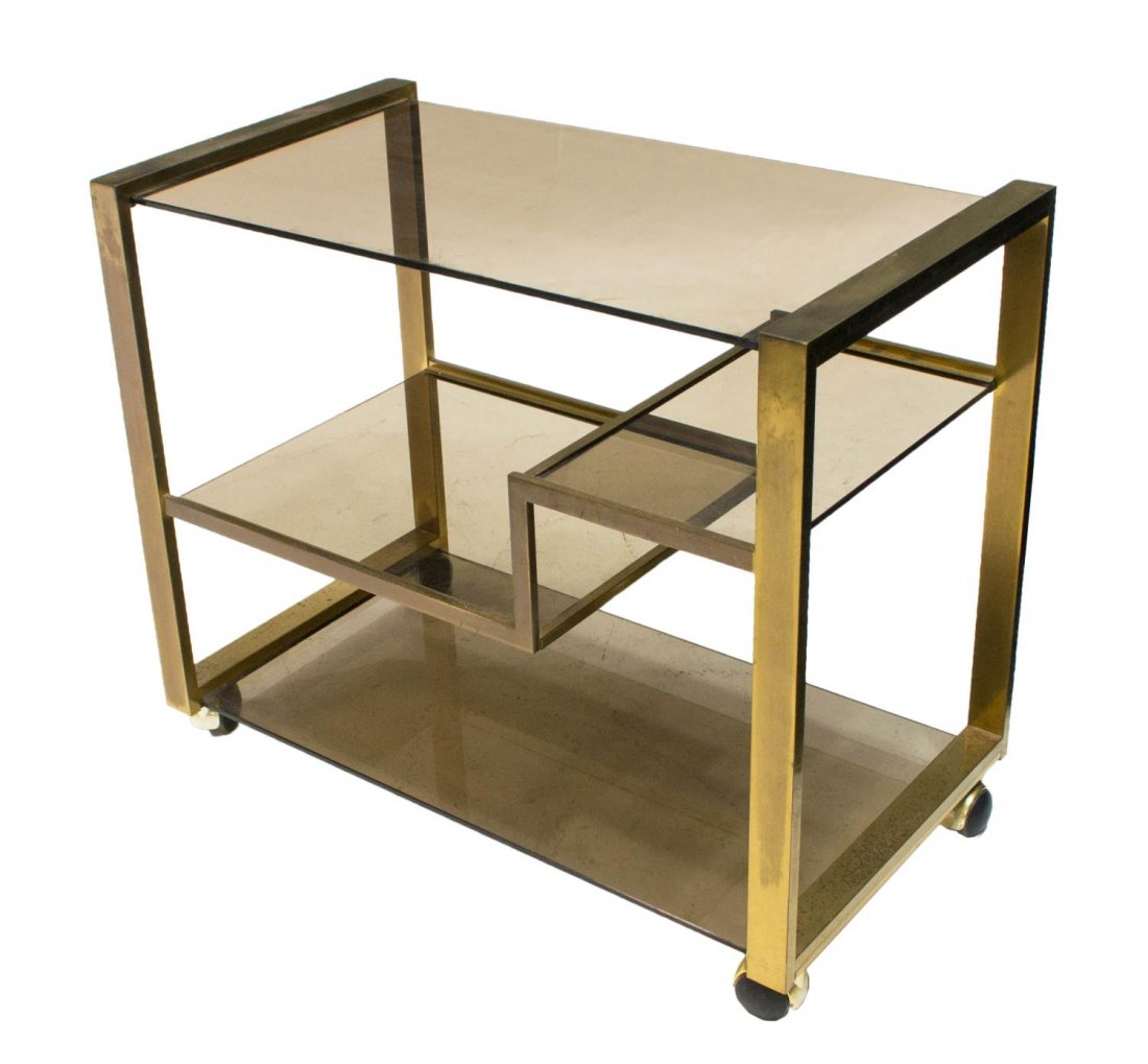 ITALIAN MODERN GILT METAL & GLASS SERVICE CART 70S: Italian modern design service cart, c. 1970s, having tinted glass shelves supported by a gilt metal frame, rising on casters, some wear to gilt, 26"h, 31"w, 17"d Start Price: $150.00