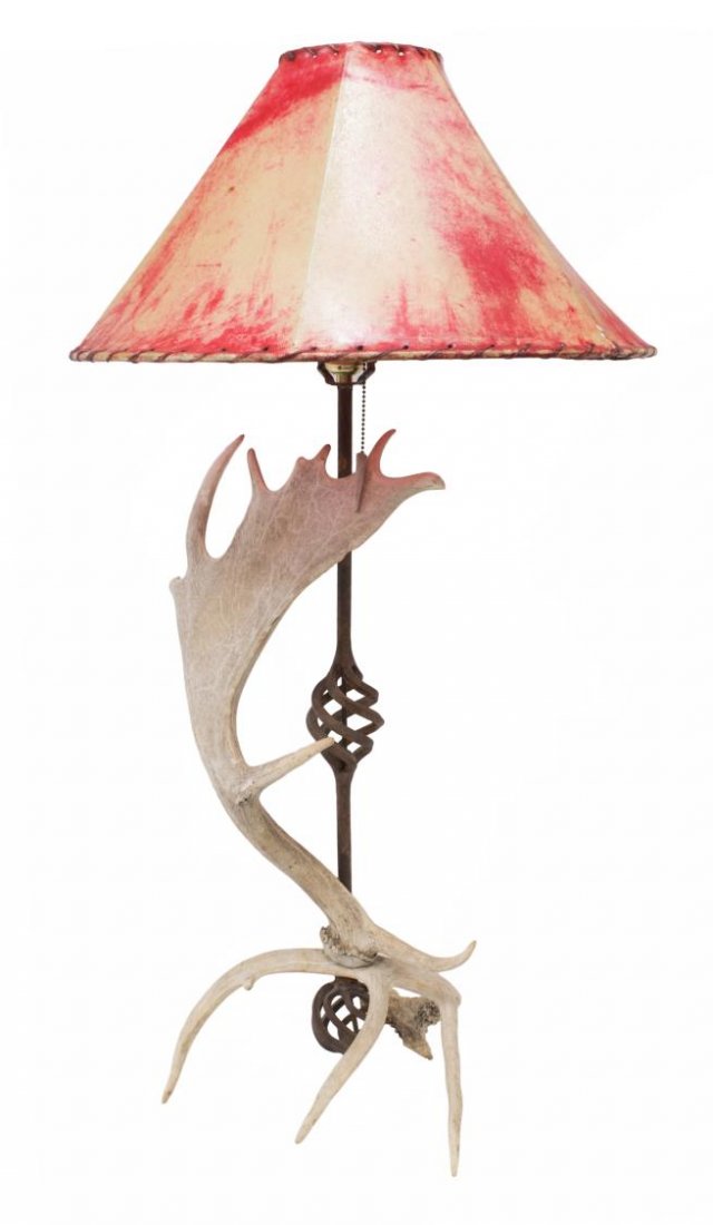 RUSTIC ANTLER & IRON TABLE LAMP WITH HIDE SHADE: Rustic table lamp fashioned from antlers, central iron standard with swirl accents, red hide shade, lacking finial, overall: 36.5"h, 7.5lbs total Start Price: $80.00