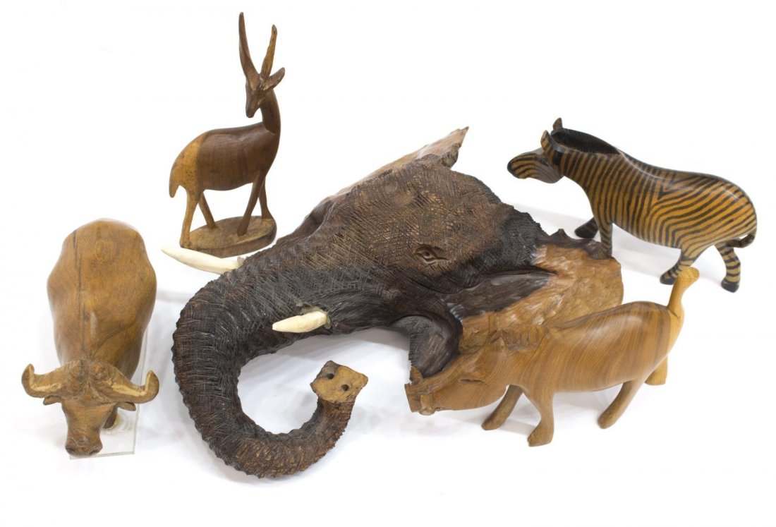 (5) AFRICAN HAND CARVED ANIMALS, ELEPHANT, ZEBRA: (lot of 5) African hand carved wood animals depicting, an elephant head, antelope, zebra, warthog and buffalo, largest: 12.25"h, 9"w, 3.75"d, total: 5.5lbs Provenance: From the trophy room of Edmond R