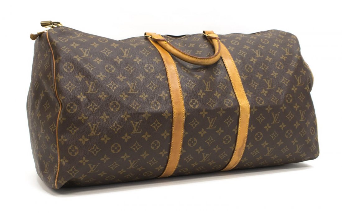LOUIS VUITTON 'KEEPALL 60' MONOGRAM DUFFLE BAG: Louis Vuitton "KeepAll 60" traveling duffle bag in monogram canvas, leather handles, trim and piping, gold tone hardware, dual zipper top opening to a brown canvas interior, retaining lock and key, pa