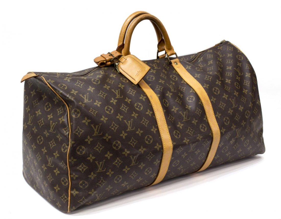 LOUIS VUITTON 'KEEPALL 60' MONOGRAM DUFFLE BAG: Louis Vuitton "KeepAll 60" traveling duffle bag in monogram canvas, leather handles, trim and piping, gold tone hardware, dual zipper top opening to a brown canvas interior, retaining luggage tag, han