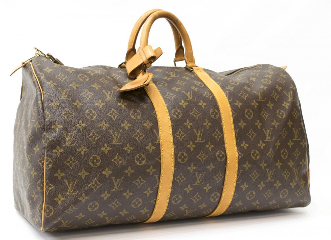 LOUIS VUITTON 'KEEPALL 55' MONOGRAM CANVAS DUFFLE: Louis Vuitton "KeepAll 55" traveling duffle bag in monogram canvas, leather handles, trim and piping, gold tone hardware, dual zipper top opening to a brown canvas interior, retaining luggage tag, han