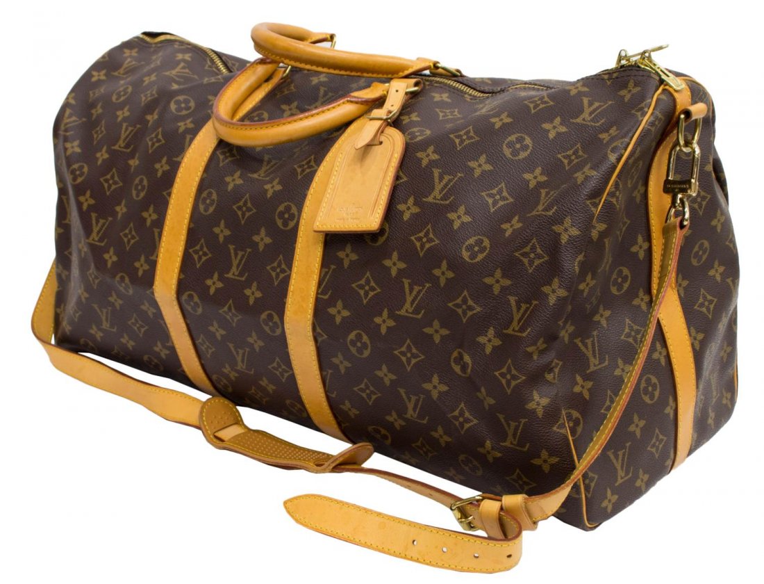LOUIS VUITTON 'KEEPALL 55' BANDOULIERE DUFFLE BAG: Louis Vuitton "Keepall 55" traveling duffle bag in monogram canvas with leather handles, piping, and trim, zipped top opening to canvas interior, retaining shoulder strap, luggage tag, patination, som
