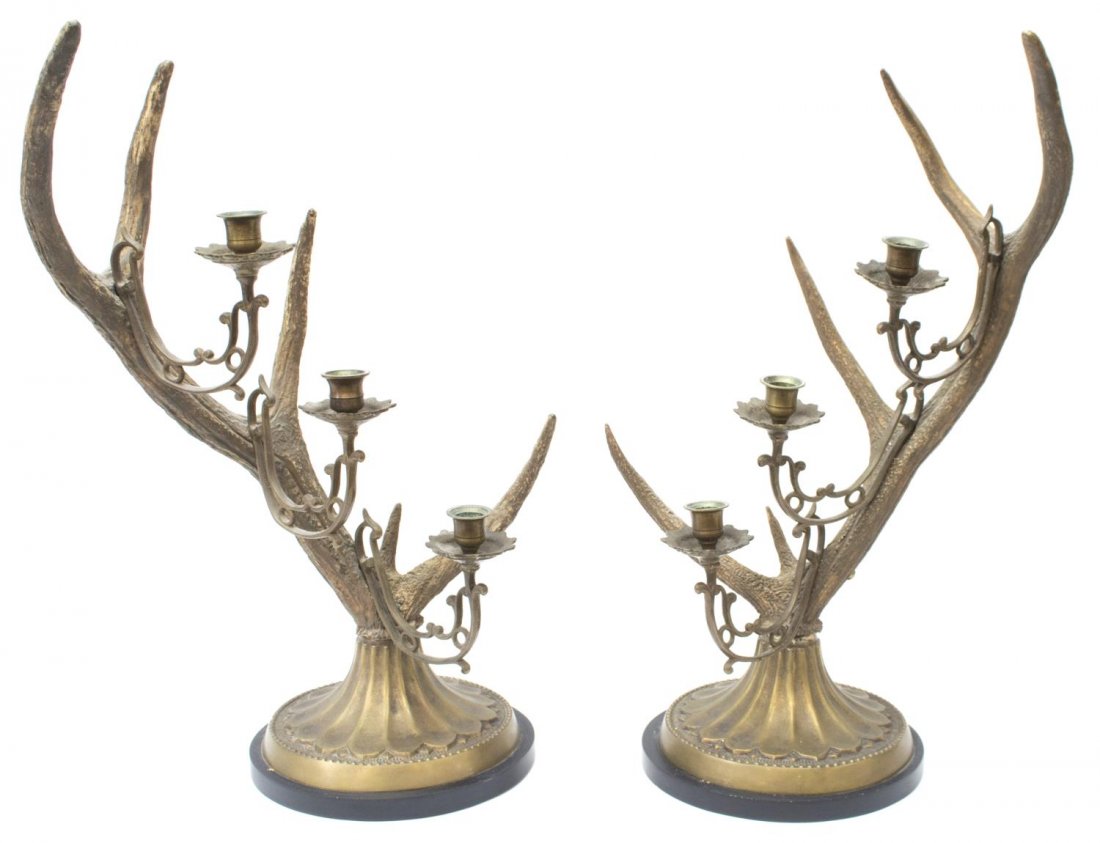 (2) LARGE THREE-LIGHT ANTLER CANDELABRAS: (pair) Large antler candelabras, each mounted with three open work brass branches ending in a candle cup on shaped bobeche, stylized brass base in a bronze patina, further raised on black circular bas