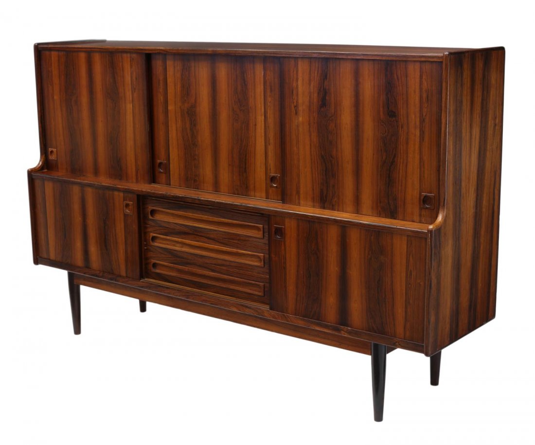 DANISH MID-CENTURY MODERN ROSEWOOD SIDEBOARD: Danish mid-century modern rosewood sideboard, c. 1960, the upper part with three sliding doors opening to a bar, drawers and shelved storage, the lower part with two sliding doors, shelves and drawers
