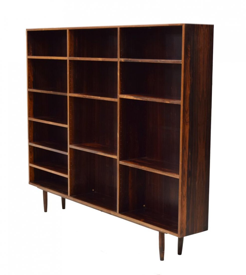 DANISH MID-CENTURY MODERN ROSEWOOD BOOKCASE: Danish mid-century modern rosewood finish sectional bookcase, 1960's, with adjustable height shelves, all rising on tapered turned supports, 59.5"h, 73"w, 10"d Start Price: $250.00