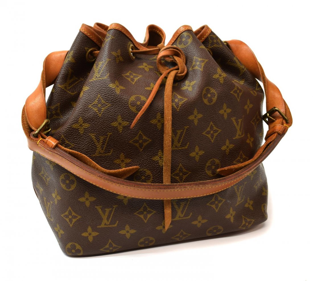 LOUIS VUITTON 'NOE PM' MONOGRAM CANVAS BUCKET BAG: Louis Vuitton "Noe PM" bucket shoulder bag in monogram canvas, having a leather adjustable strap, trim, and piping, the drawstring top opening to brown canvas lined interior, patination, spotting and 