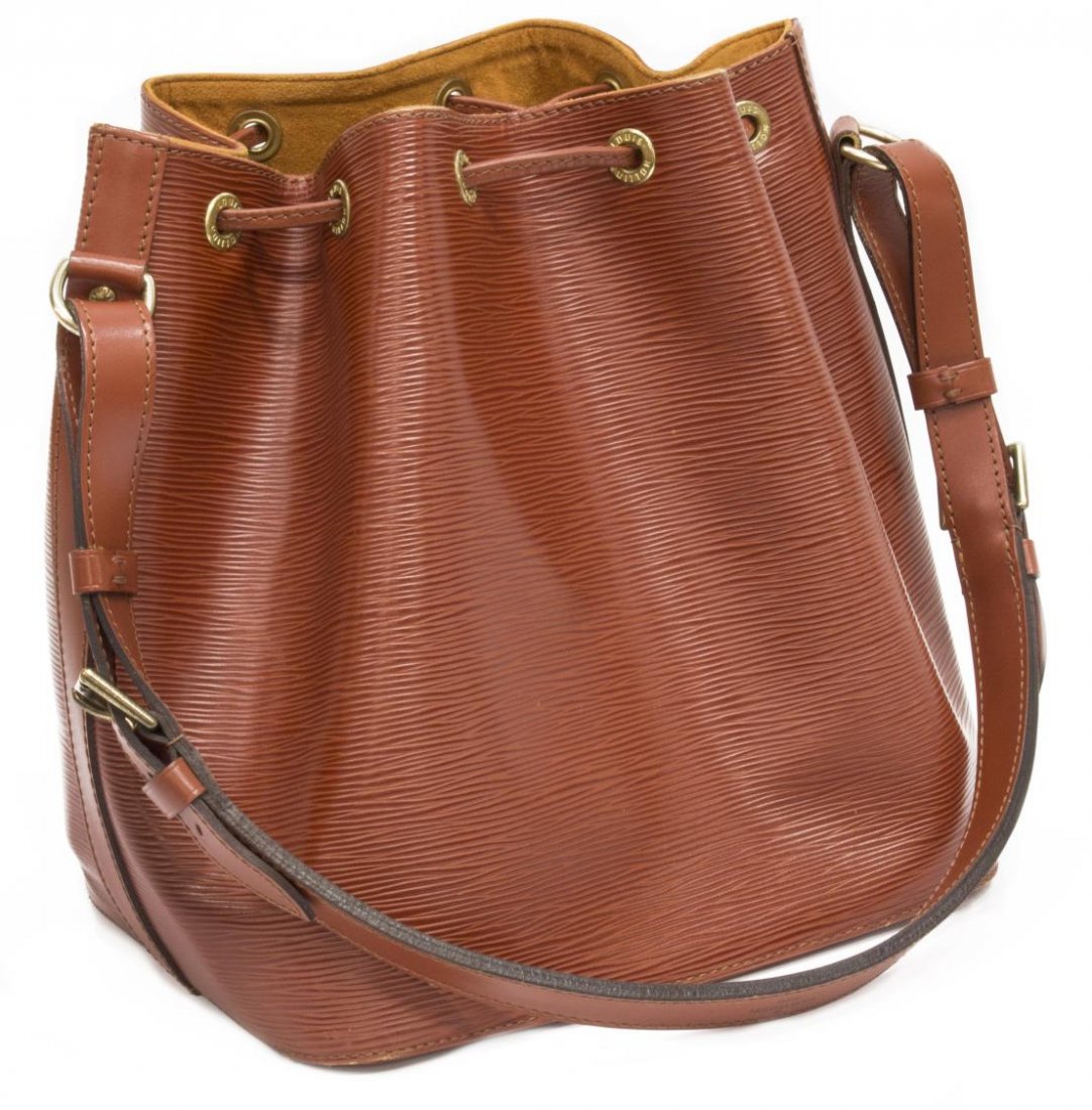 LOUIS VUITTON 'NOE PM' EPI LEATHER BUCKET BAG: Leather Vuitton "Noe PM" drawstring bucket bag in tan Epi leather, with adjustable strap, gold tone hardware, drawstring top opens to a harvest orange interior, patination and scuffing to bottom edges