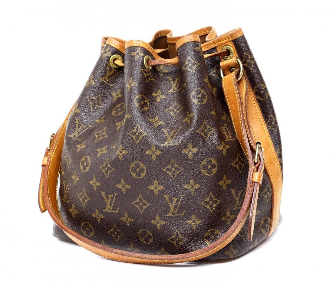 LOUIS VUITTON NOE PM MONOGRAM BUCKET BAG: Louis Vuitton "Noe PM" bucket shoulder bag in monogram canvas, having a leather adjustable strap, trim, and piping, the drawstring top opening to brown canvas lined interior, patination, spotting, and