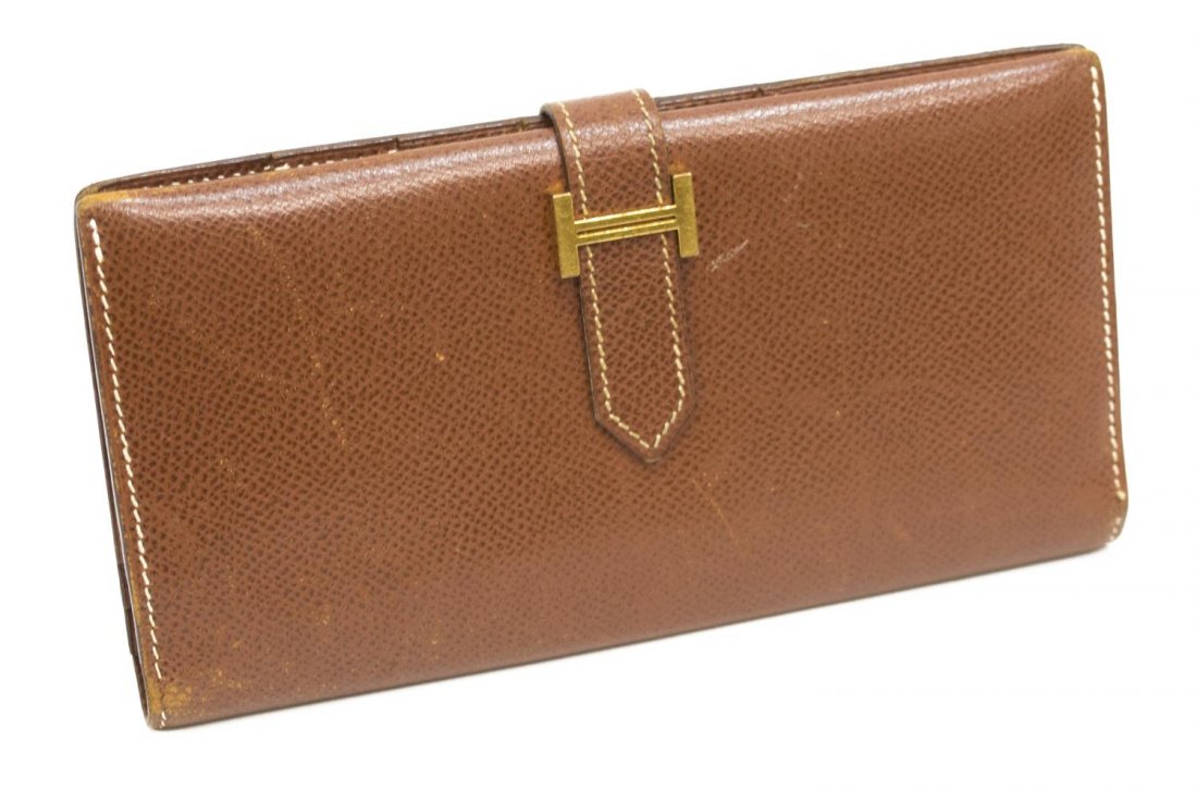HERMES BROWN LEATHER BI-FOLD 'BEARN' WALLET: Hermes brown leather bi-fold "Bearn" wallet, having gold tone hardware, slip leather tab opening to interior with a full length zippered pocket and a bill compartment on one side, five card slots and 