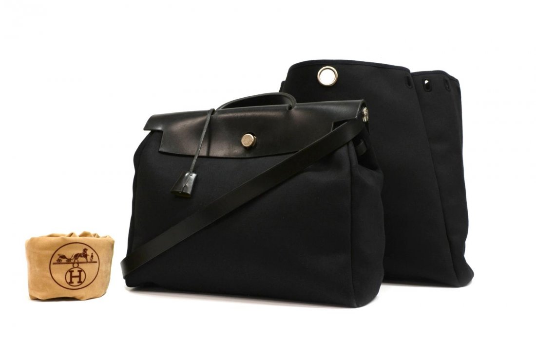 (2) HERMES HERBAG GM WITH INTERGABLE LARGER BAG: (2 pieces) Hermes "Herbag GM" in black canvas with black leather handle, trim and strap, silver tone hardware, retaining H lock only and two keys, accompanied by larger interchangeable bag and Hermes 