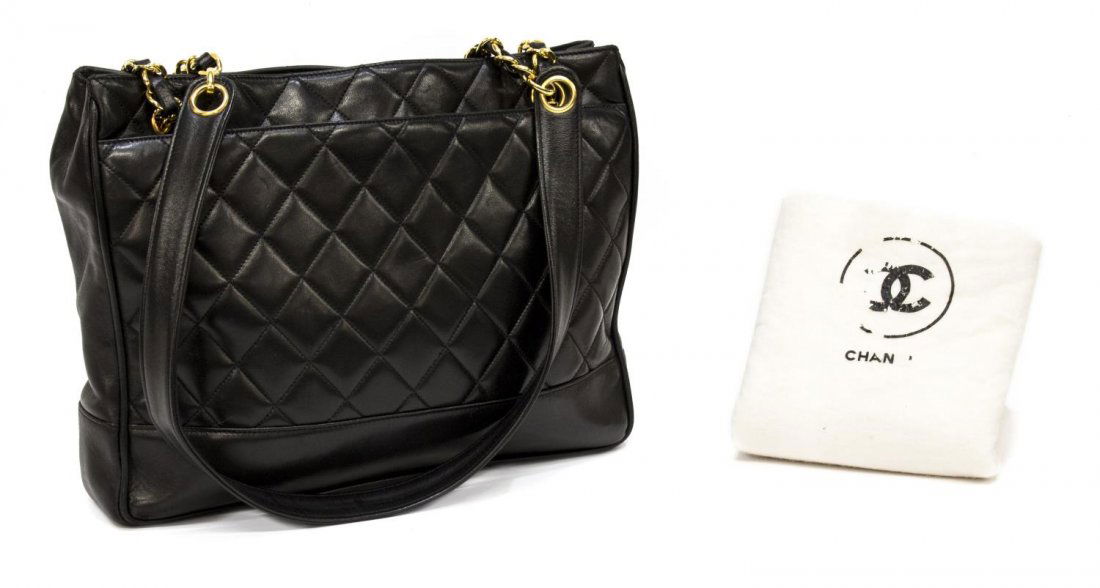 CHANEL QUILTED BLACK LEATHER DOUBLE HANDLED TOTE: Chanel quilted tote bag in black lambskin leather, gold tone hardware, having two slot pockets to exterior, the two shoulder straps over the snap closure top, opening to leather lined interior with tw