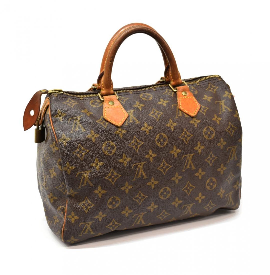 LOUIS VUITTON 'SPEEDY 30' MONOGRAM CANVAS HANDBAG: Louis Vuitton "Speedy 30" handbag in monogram canvas, leather handles and piping, gold tone hardware, zipper top opens to brown fabric lined interior featuring single hanging pocket, small white mark 