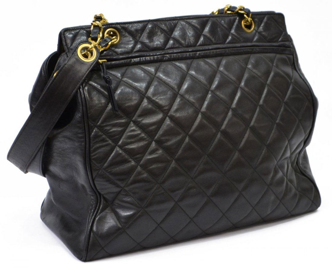 CHANEL BLACK QUILTED LEATHER SHOULDER BAG: Chanel quilted shoulder bag in black lambskin leather, having gold tone hardware, long zipper and slot pockets to exterior, double shoulder straps over the zipper top, satin lined interior with two zi
