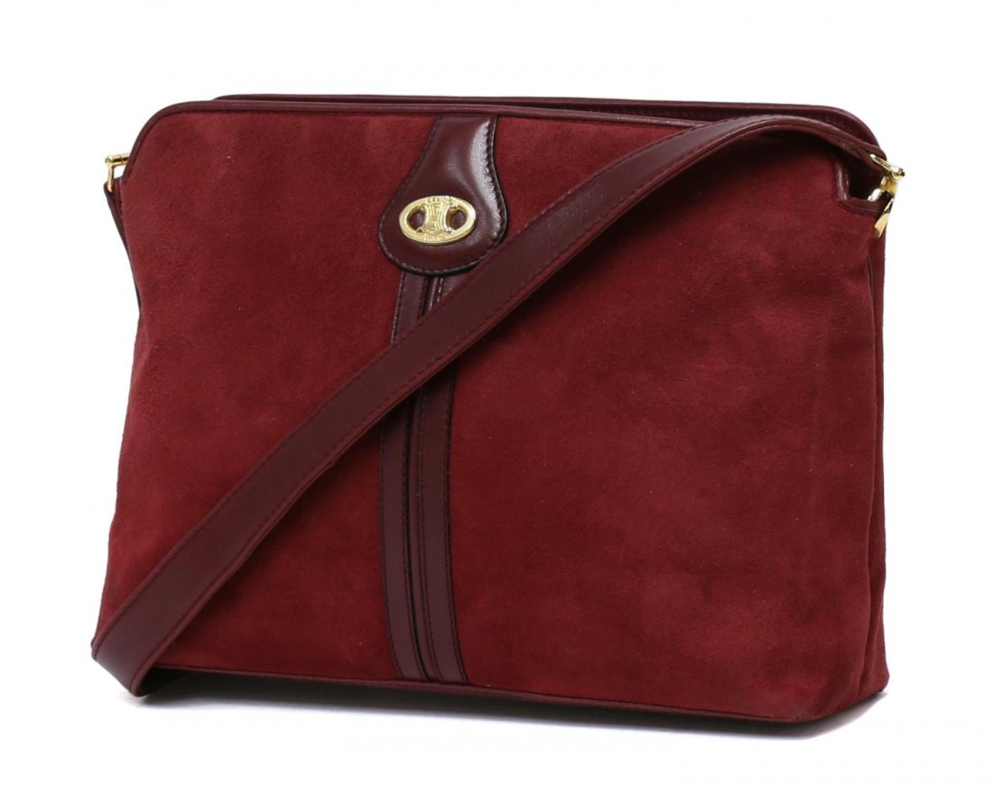 CELINE BURGUNDY SUEDE & LEATHER SHOULDER BAG: Celine shoulder bag in burgundy suede with leather strap and gold tone hardware, red interior with two compartments and one side zipper pocket, some indentations to suede, bag: approx 7"h, 9.5"w, 3"d,