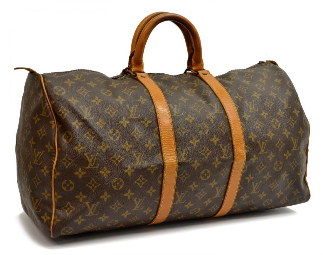 LOUIS VUITTON 'KEEPALL 50' MONOGRAM DUFFLE BAG: Louis Vuitton "KeepAll 50" travelling duffle bag in monogram canvas, having leather handles, piping and trim, gold tone hardware, zip top opening to brown canvas lined interior, lacking lock and key, 