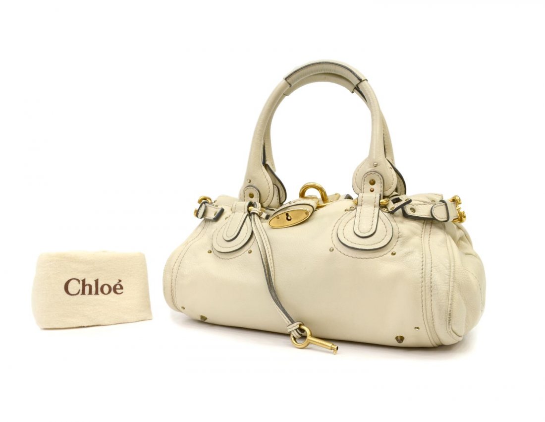 CHOLE PADDINGTON BEIGE LEATHER LOCK PURSE: Chloe "Paddington MM" in beige leather with gold tone hardware, two exterior slot pocket, top unzips to beige cloth lined interior featuring cell and zipped pockets, on small metal feet, with signatur