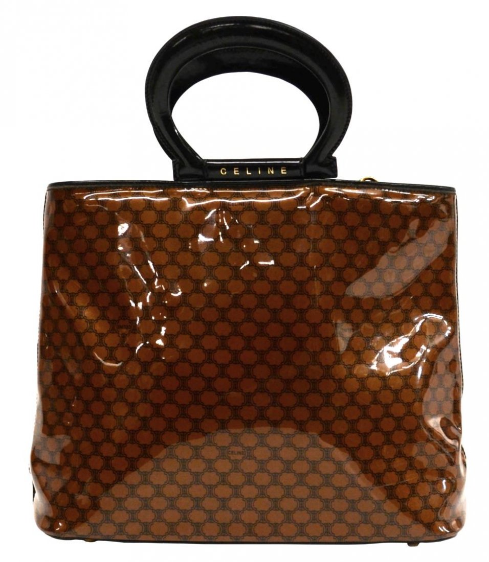 CELINE MACADAM MONOGRAM HANDBAG LEATHER HANDLES: Celine Paris handbag in brown macadam monogrammed vinyl, black leather cutout round handles and trim, gold tone hardware, opening to black patterned lined interior with two full length single zip pock