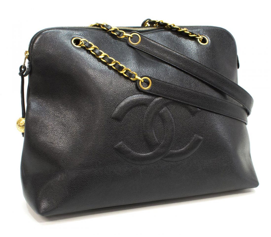 CHANEL BLACK CAVIAR LEATHER CC LOGO SHOULDER BAG: Chanel black caviar leather shoulder bag, CC logo stitched to one side, dual handles with partial gold tone chain, lined interior with two zipped pockets, accompanied by dust bag, bag only: approx 13"