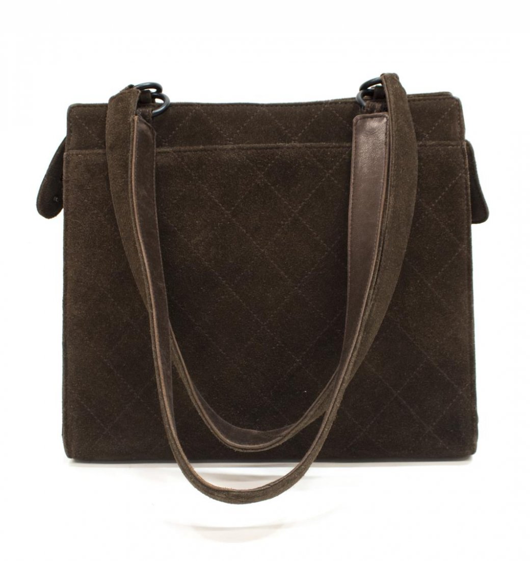 CHANEL STITCHED BROWN SUEDE SHOULDER BAG: Chanel brown suede stitched shoulder bag, black Chanel tag to one side, slot pockets, dual handles, zippered top opens to one zippered and one slot pocket, 9.75"h, 11"w, 4.5"'d, 1.25lbs *Provenance: L