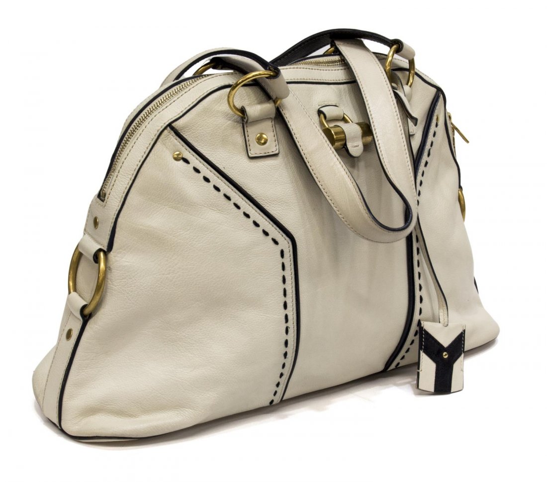 YVES ST LAURENT "MUSE" WHITE & BLACK LEATHER PURSE: Yves St. Laurent "Muse" bag in white and black leather, gold tone hardware, satin lined interior with one zipper and one cell pocket, on gilt metal feet, some small marks to the white leather, black s