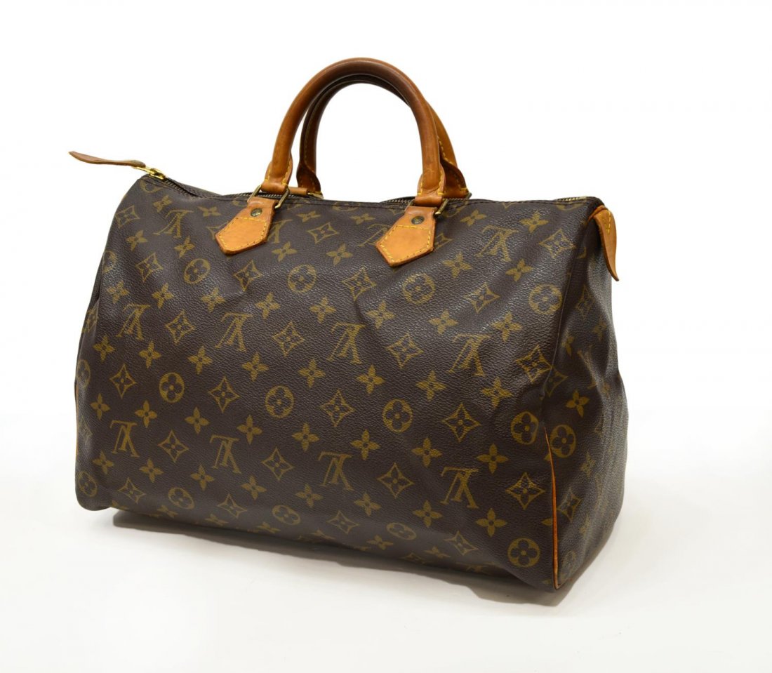 LOUIS VUITTON SPEEDY MONOGRAM CANVAS HANDBAG: Louis Vuitton "Speedy 30" in classic monogram canvas, leather handles and trim, interior with hanging slot pocket, wear and patination to leather, bag: approx 8.5"h, 11.5"w, 7.5"d, 1lb Start Price: $1