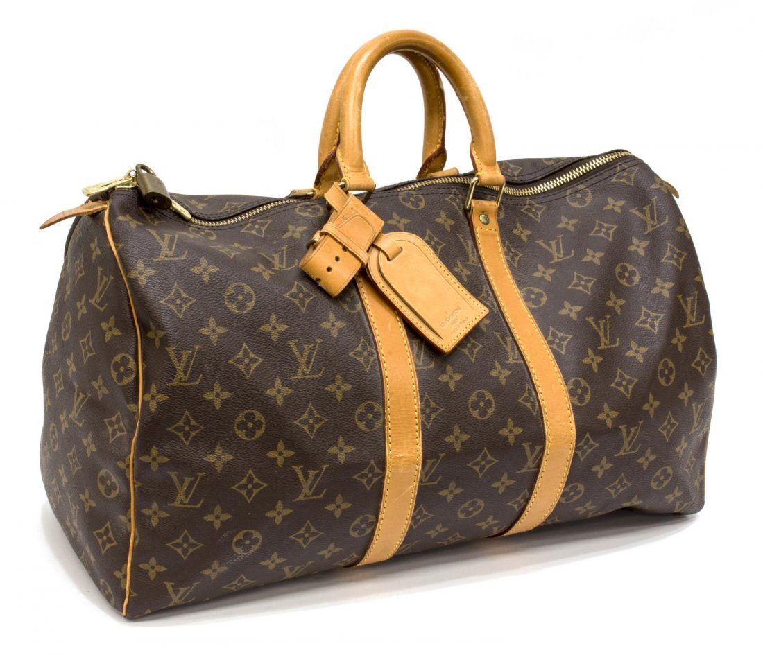 LOUIS VUITTON MONOGRAM CANVAS 'KEEPALL 45' DUFFLE: Louis Vuitton monogram canvas "KeepAll 45" traveling duffle bag, leather handles and trim, accompanied by luggage tag, lock (no key), some scuffs, creasing and patination, approx 10"h, 18"l, 8.5"d, 1.