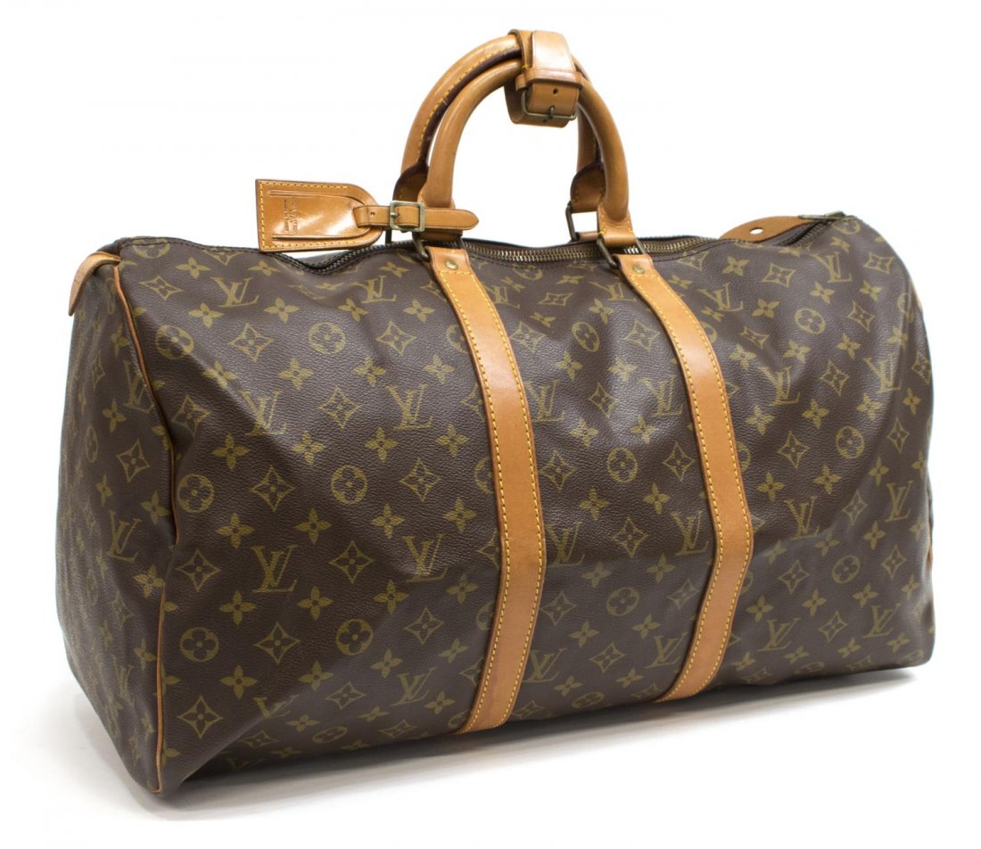 LOUIS VUITTON 'KEEPALL 50' MONOGRAM CANVAS DUFFLE: Louis Vuitton "Keepall 50" traveling duffle bag in monogram canvas, having leather handles, piping and trim, zipped top opening to brown fabric interior, retaining luggage tag and lock, patination, sp