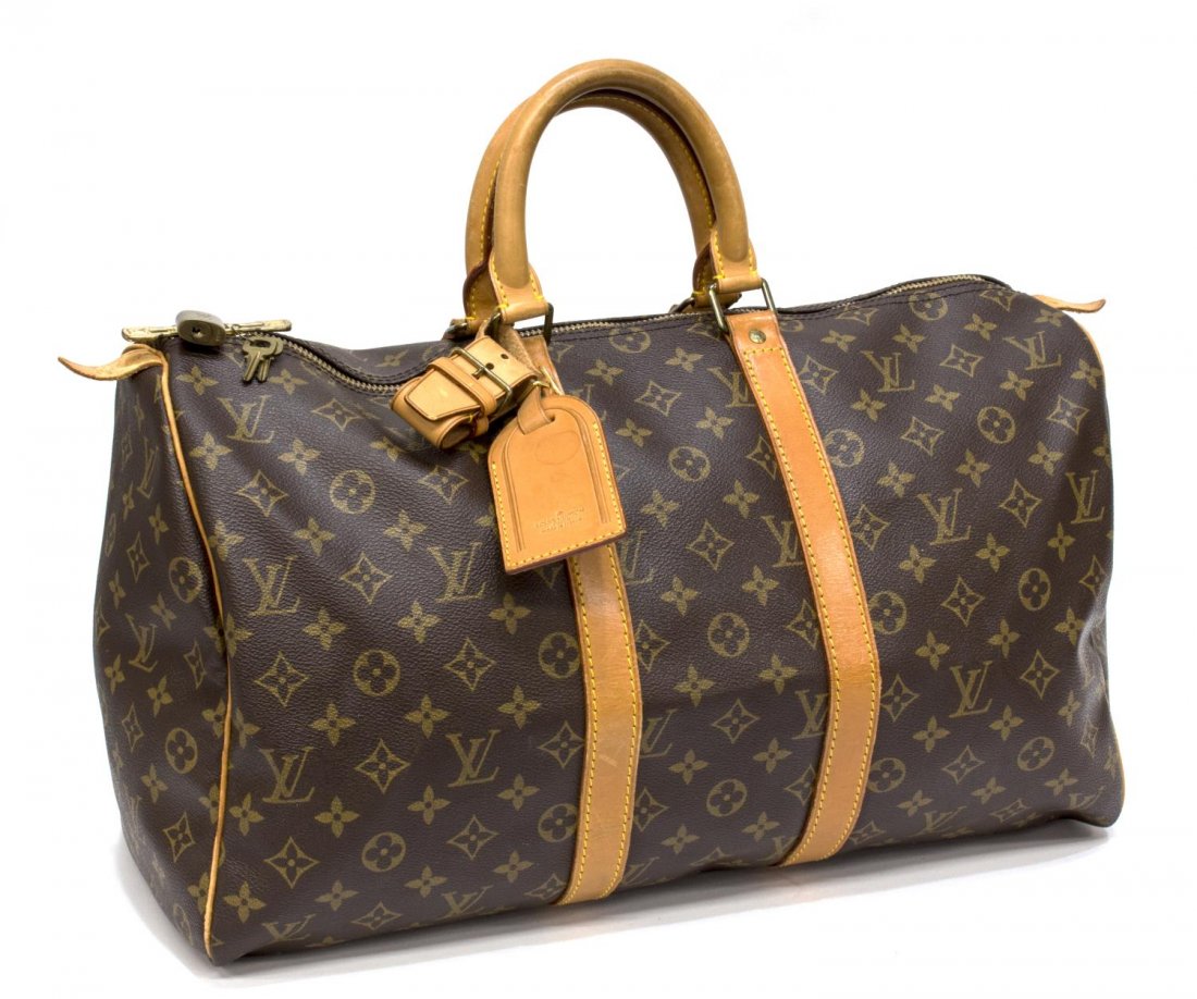 LOUIS VUITTON MONOGRAM 'KEEPALL 45' DUFFLE BAG: Louis Vuitton monogram canvas "KeepAll 45" traveling duffle bag, leather handles and trim, accompanied by luggage tag, lock and keys, creasing and patination, some spotting, approx 10"h, 18"l, 8.5"d, 
