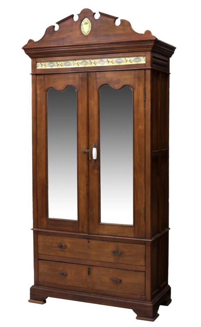 BRITISH COLONIAL TILED TEAKWOOD CABINET 19TH C.: British Colonial tiled teakwood cabinet, 19th c., the carved crest centered by a glazed tile, above a frieze of glazed tiles, above two mirrored doors opening to shelved interior and two long shelves,