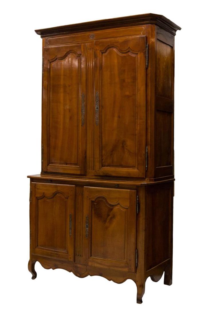 FRENCH 18TH C. CHERRYWOOD DEUX CORPS CABINET: French Louis XV cherrywood deux corps cabinet, 18th c., having a protruding cornice over two paneled doors, the lower part with a pull out tray over two doors, rising on cabriole legs, 100.5"h, 53.5"w