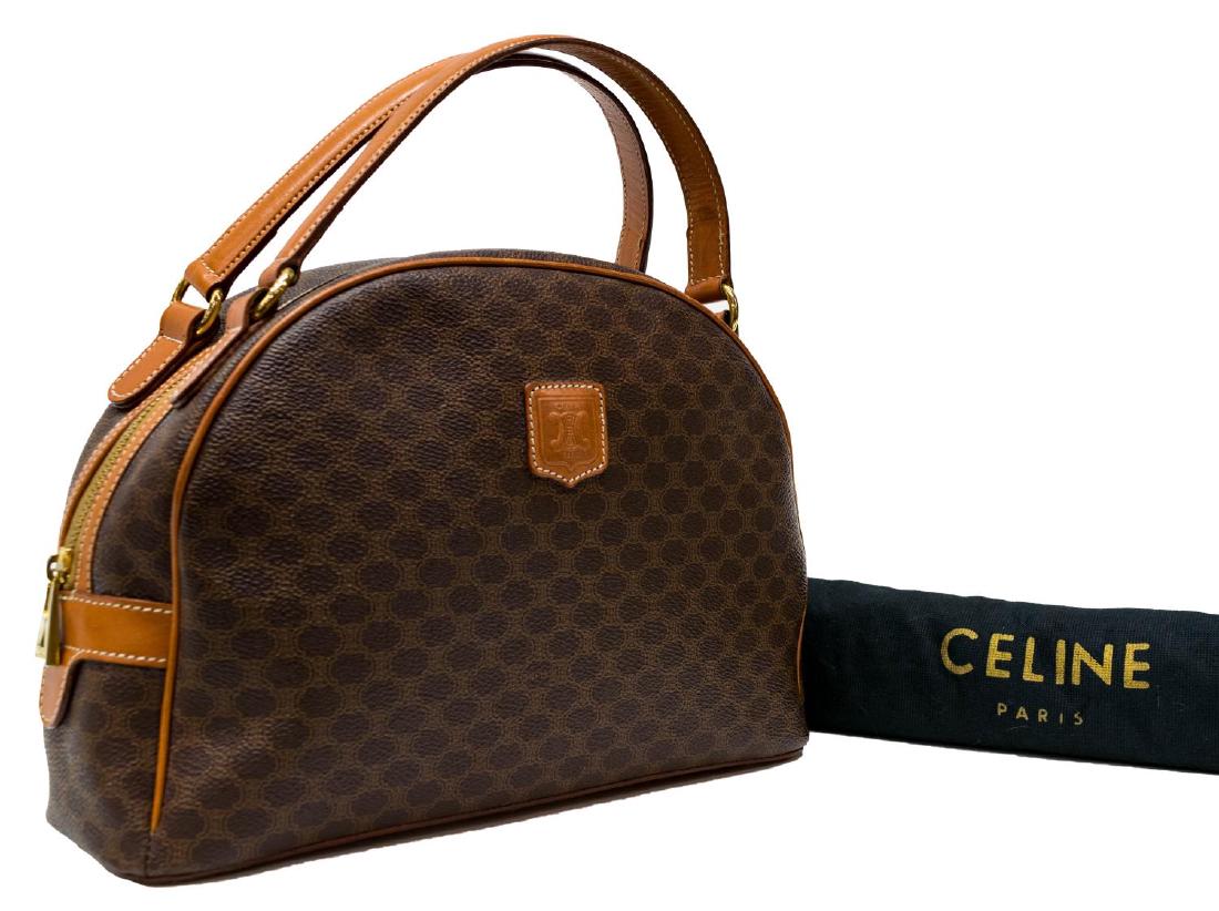 CELINE MACADAM MONOGRAM CANVAS & LEATHER HAND BAG: Celine Paris handbag in "Macadam" monogram canvas, leather trim, gold tone hardware, duel flat handles over the arched zipper top, opening to tan interior with single zipper pocket, accompanied by dus