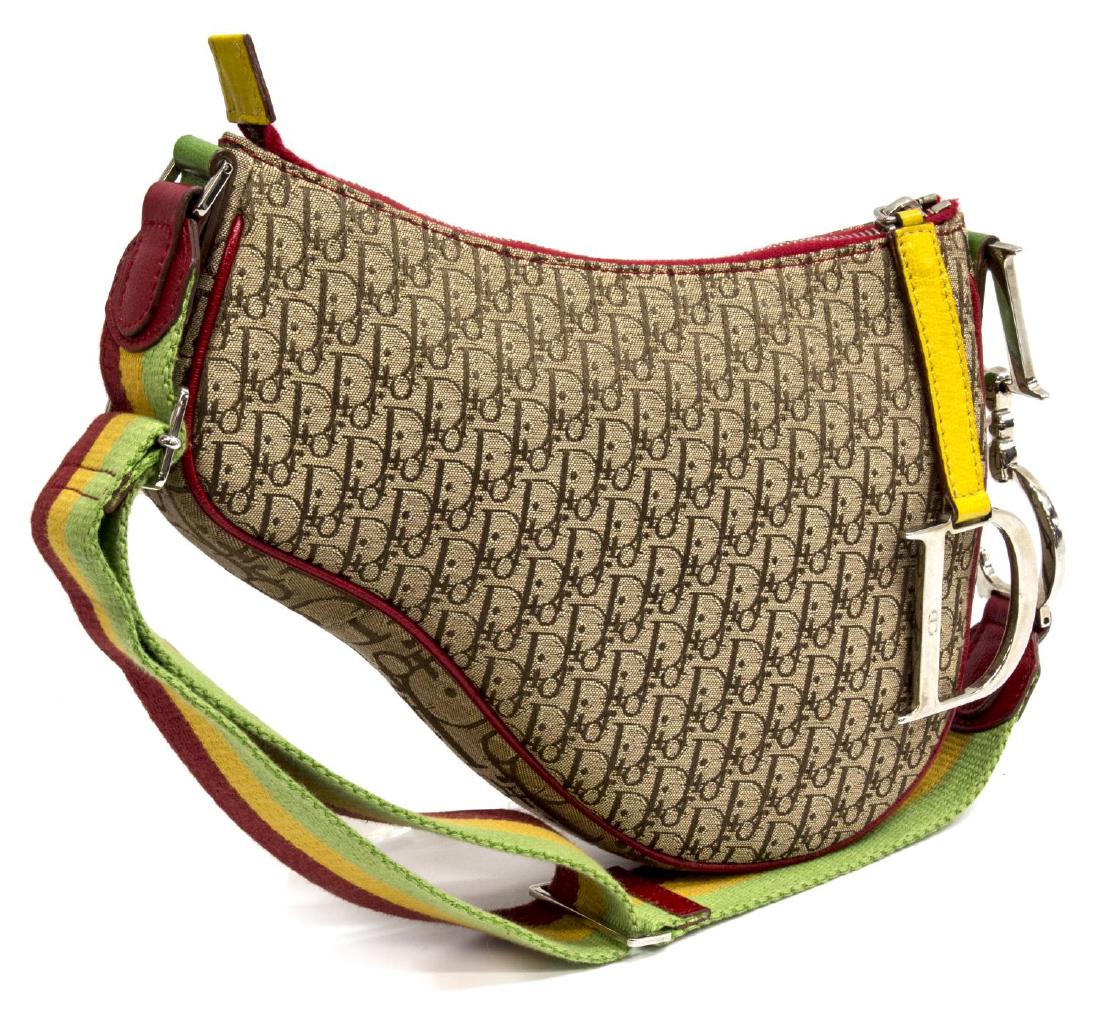CHRISTIAN DIOR RASTA SADDLE PM SHOULDER BAG: Christian Dior "Saddle PM" pouch in monogram canvas, adjustable fabric strap, red, green and yellow leather piping and accents, silver tone hardware, zippered pocket to interior, some wear and discolo