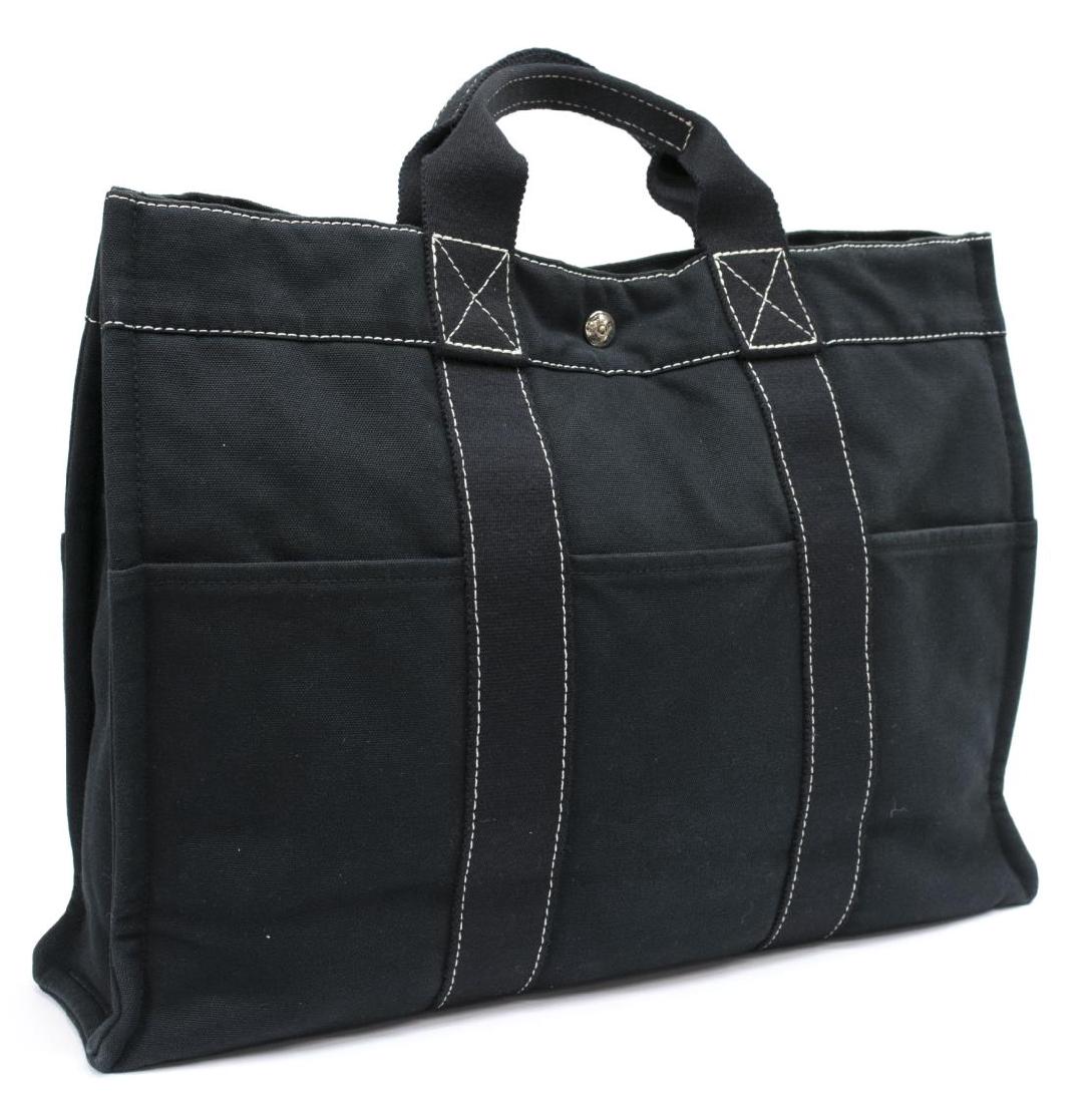 HERMES 'FOURRE-TOUT PM' BLACK CANVAS TOTE BAG: Hermes "Fourre-Tout PM" handbag in black padded canvas with white stitching, slotted pockets to exterior, silver tone hardware, double handles and snap top, zippered pocket to interior, bag: approx 12