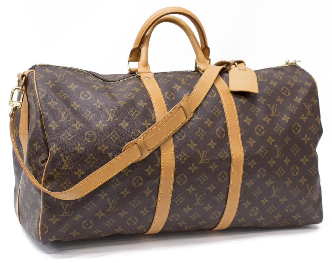 LOUIS VUITTON 'KEEPALL 55' MONOGRAM DUFFLE W/STRAP: Louis Vuitton "Keepall 55" traveling duffle bag in monogram canvas, having leather handles, shoulder strap, trim, and piping, zipped top opening to brown canvas lined interior, retaining luggage tag a