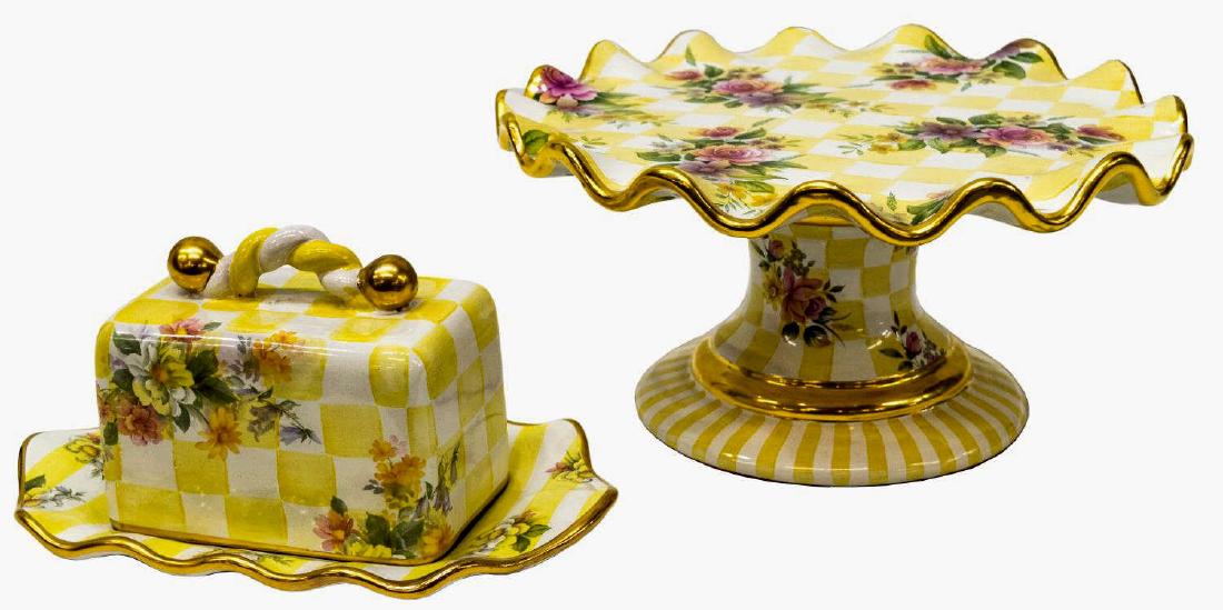 (2) MACKENZIE-CHILDS 'HONEYMOON' TABLE ARTICLES: (2) MacKenzie-Childs parcel gilt "Honeymoon" terra cotta "Dandy Lion" color table articles, comprising: (1) cake stand, in having a circular plate with scalloped border, with floral transfer design, o