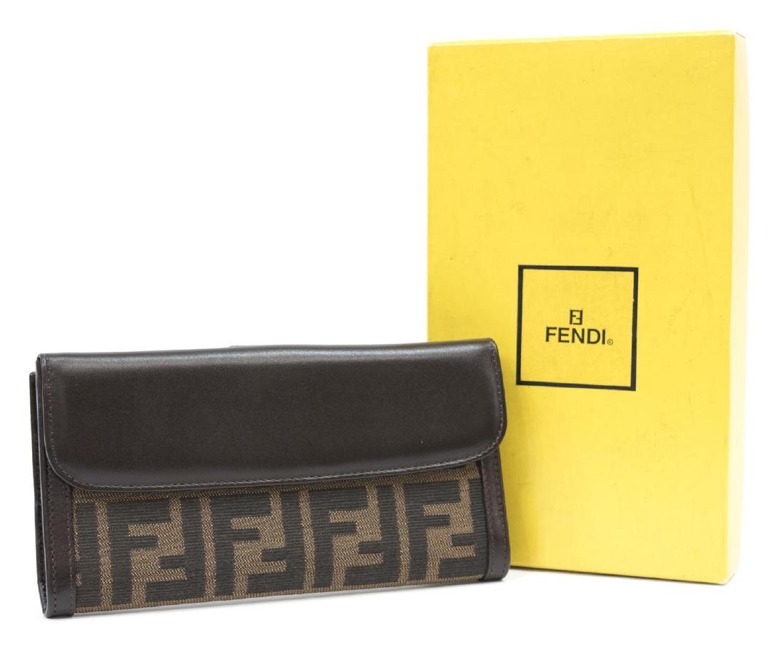 FENDI MONOGRAM CANVAS LONG BIFOLD WALLET: Fendi long bifold wallet, in monogrammed canvas, with brown smooth leather flap top and accents, each side opening to slotted pockets, retaining original box, a few light scuff marks to leather, wear